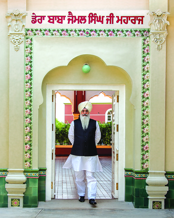 a man standing in front of an entrance to a building