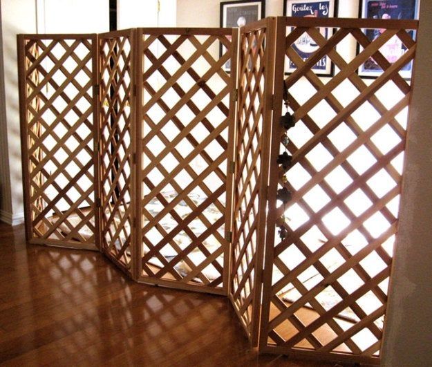 a wooden room divider sitting on top of a hard wood floor