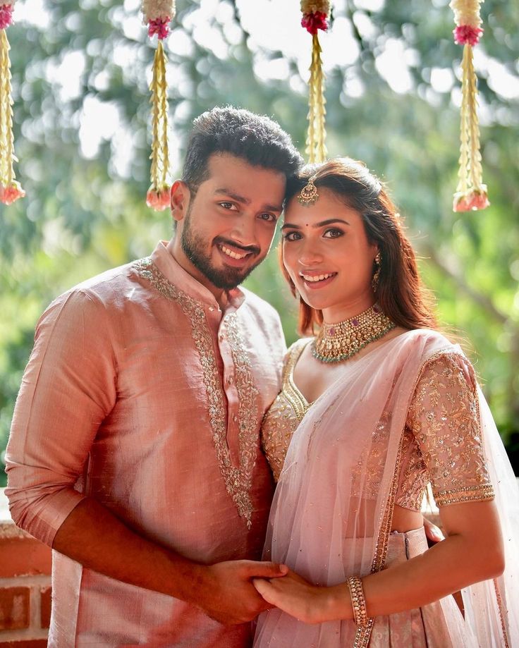 a man and woman dressed in pink posing for the camera