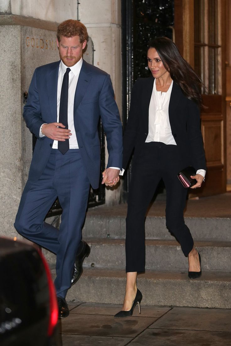 prince harry and his wife are walking down the steps