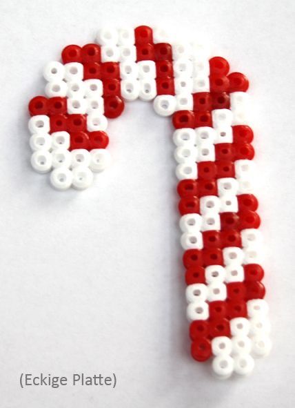 a close up of a candy cane made out of legos on a white surface