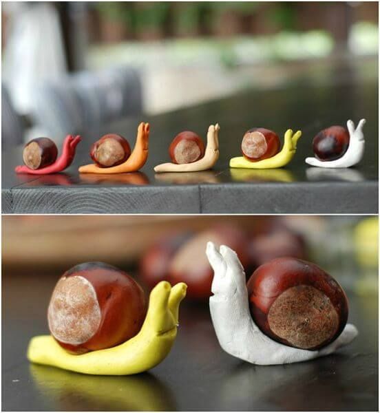 snail figurines sitting on top of each other next to bananas and chestnuts