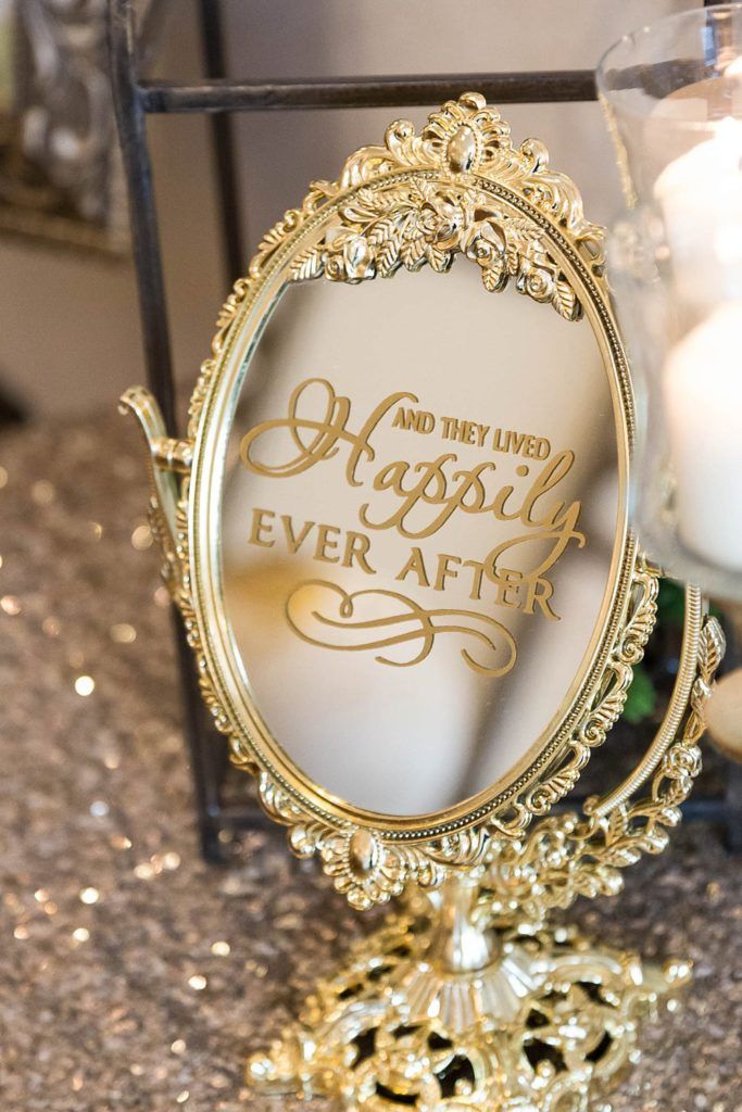 an ornate mirror with the words happily ever after written on it and lit candles in the background