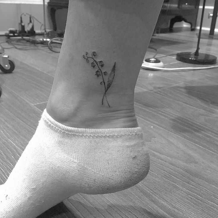 a small flower tattoo on the ankle