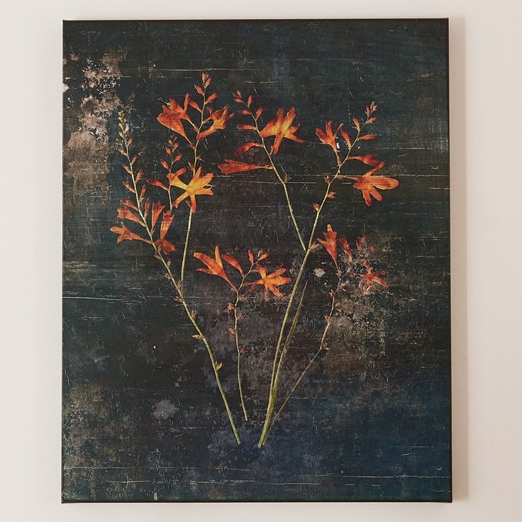 an abstract painting with orange flowers on a black background