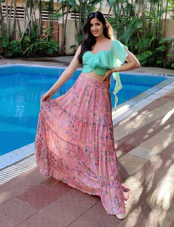 Mint Green sequin and thread embroidered georgette blouse with ruffle detail on one shoulder and pink printed chiffon gathered lehenga.Dry Clean only. Summer Embroidered Georgette Lehenga, Summer Floral Print Georgette Lehenga, Bohemian Multicolor Georgette Lehenga, Floral Ruffle Lehenga, Pink Floral Embroidered Semi-stitched Lehenga, Georgette Blouse, Green Sequins, Mint Green, Lehenga