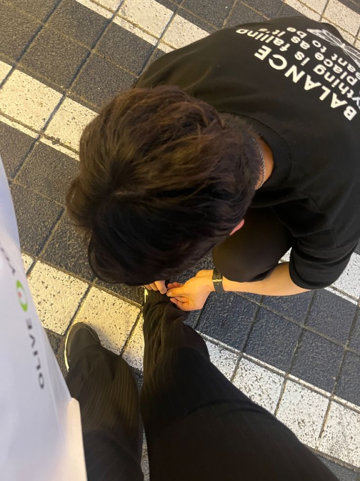 a person standing on the ground eating something