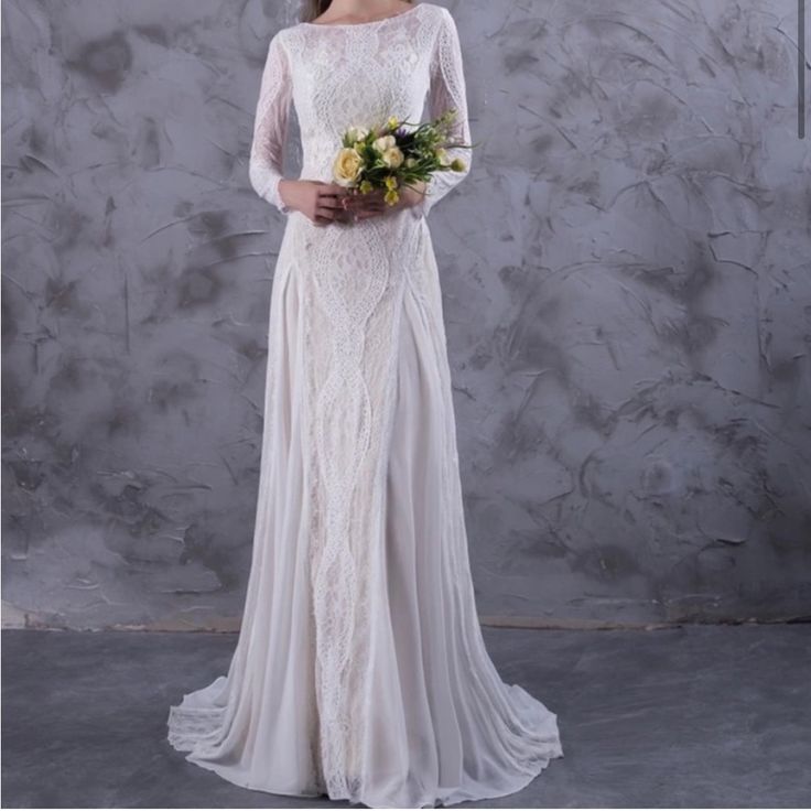 a woman in a white wedding dress holding flowers