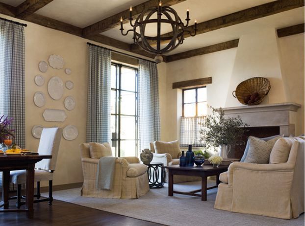 a living room filled with furniture and a chandelier