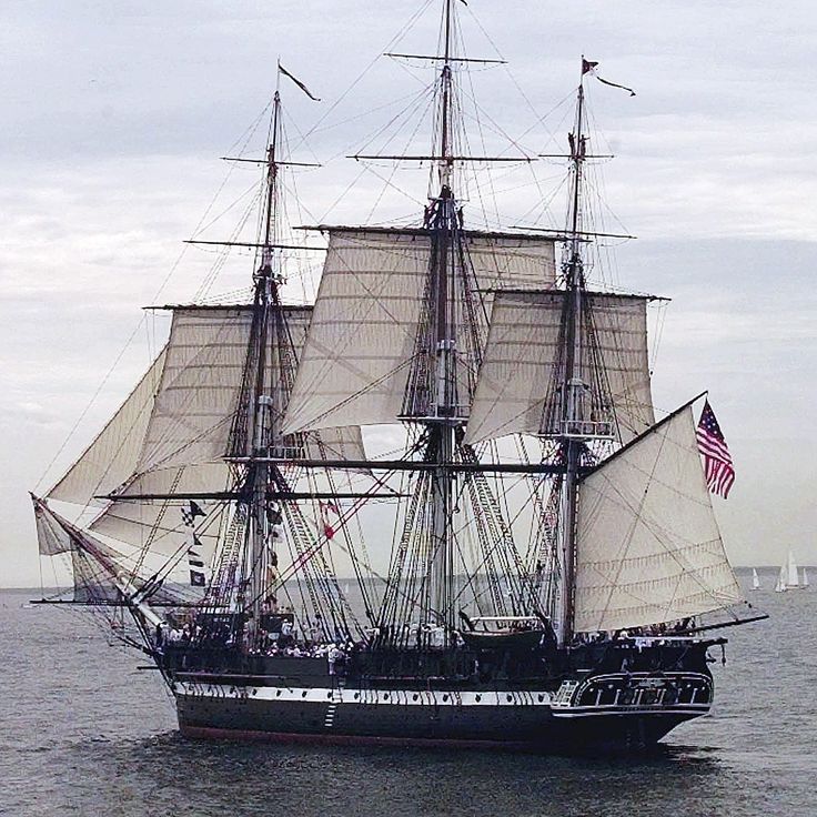 an old sailing ship in the middle of the ocean