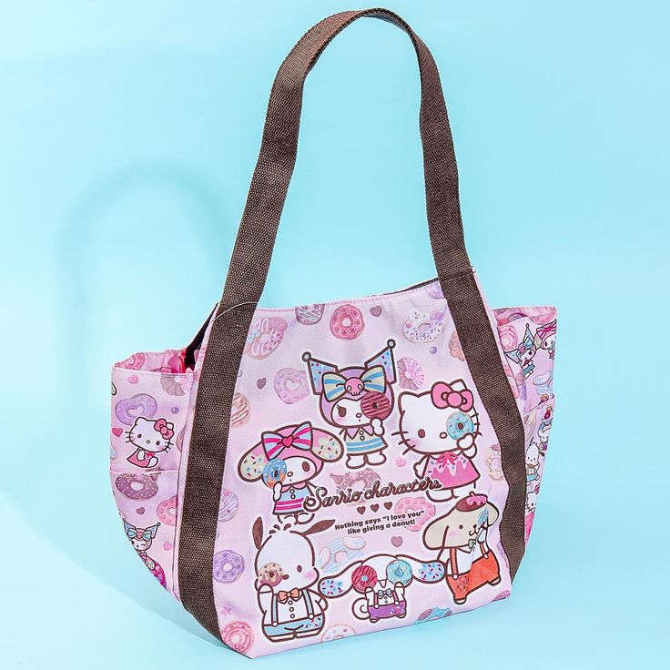 This kawaii balloon-style bag features cute illustrations of the popular Sanrio Characters all holding colorful donuts! Use this shoulder bag to school or work to add a dose of cuteness to your outfit. Features multiple inner and side pockets Comes with a magnetic button closure Pink School Bag With Cartoon Print, Pink Kawaii Bag With Cute Design, Pink Cartoon Print Travel Bag, Kawaii Shoulder Bag For Everyday And Back To School, Kawaii Multicolor Bags With Cute Design, Cute Hello Kitty Print Bags For Back To School, Pink Kawaii Back-to-school Bags, Kawaii Shoulder Bag With Cute Design For Everyday Use, Cute School Shoulder Bag With Zipper