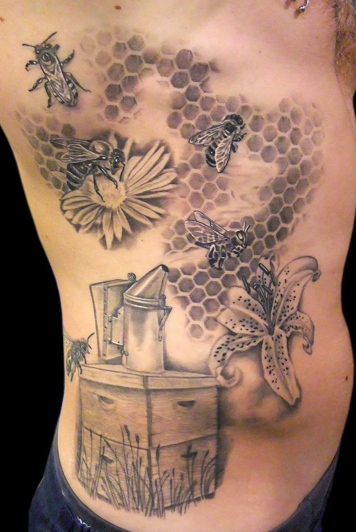 a man's back with bees and honeycombs on his stomach, as well as some flowers