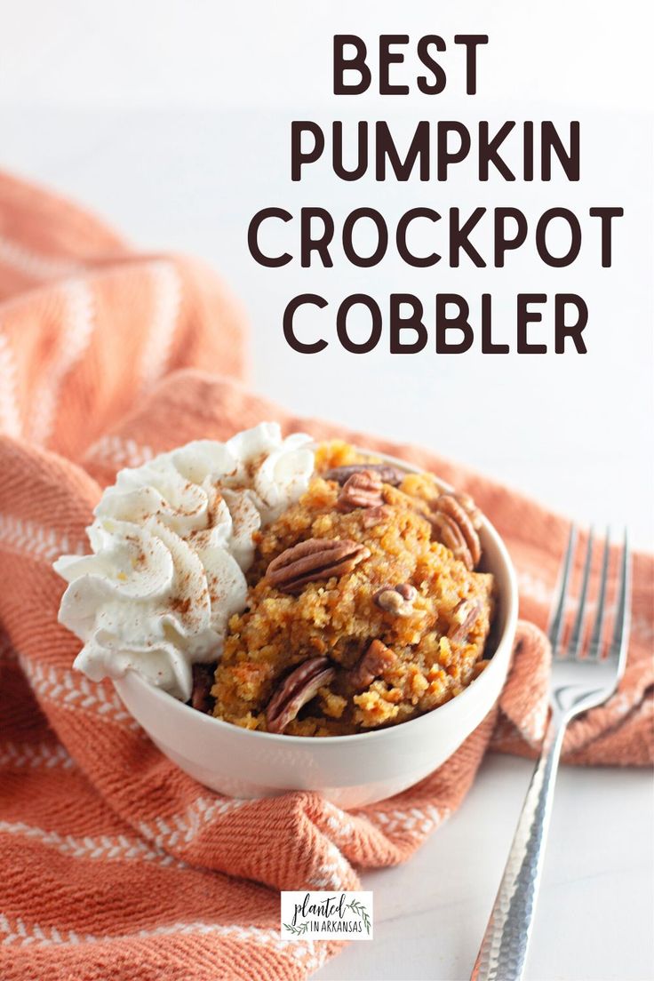 the best pumpkin crockpot cobbler is in a white bowl with whipped cream and pecans