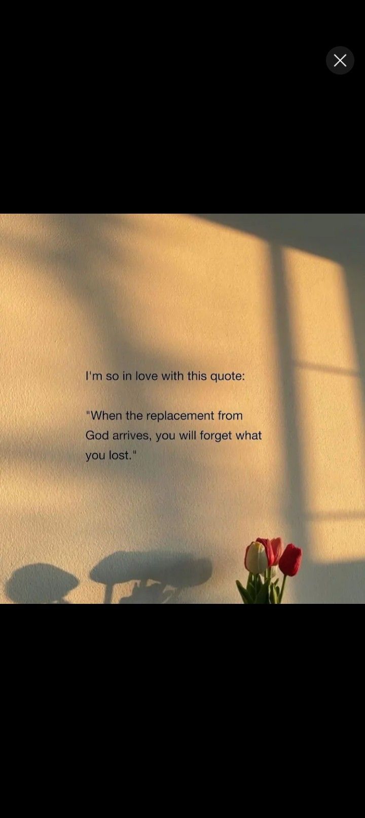 a vase with flowers sitting on top of a table in front of a wall that says, i'm so in love with this quote