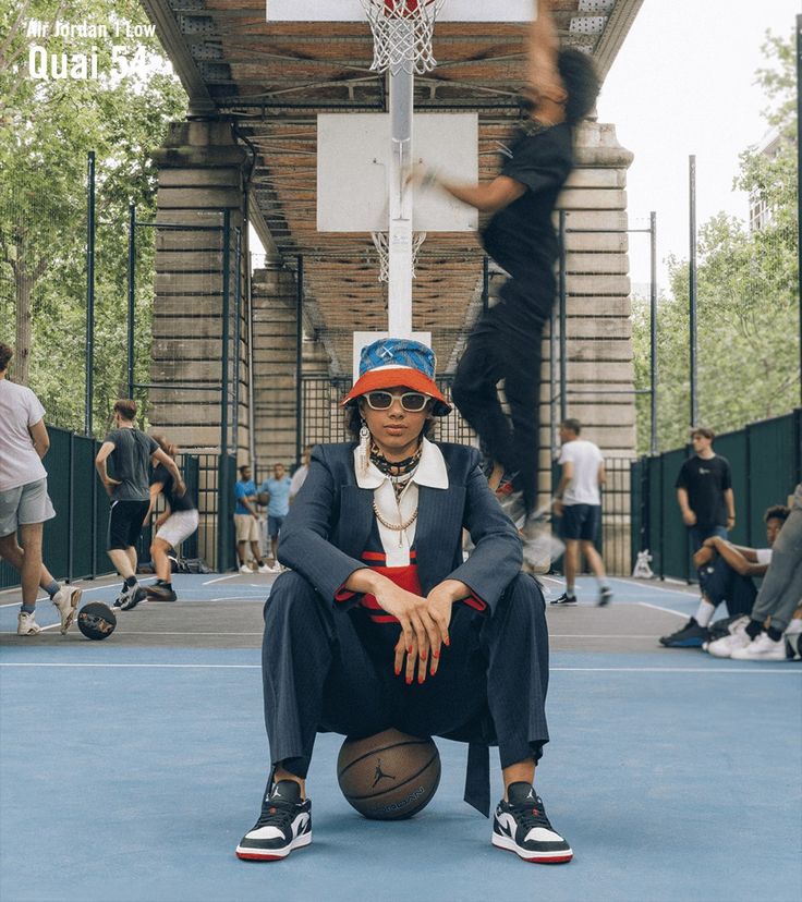 a man sitting on top of a basketball court