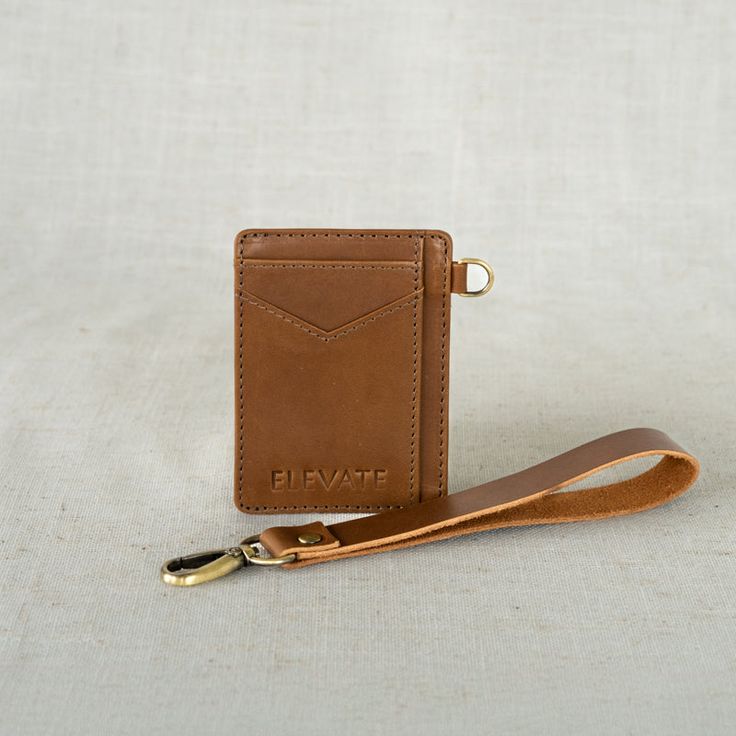 Vi·a: traveling through (a place) en route to a destination. A petite powerhouse, our handcrafted Via Wristlet Wallet is perfect for carrying the essentials. Thoughtfully designed to hold all your cards + cash, and is conveniently smaller than other wallets to boot. Designed with a detachable wristlet so you can clip this beauty to your favorite handbags & totes for easier access! Ethically made and sustainably sourced, this piece is a no-brainer for those needing an on-the-go card carrying acce Card Holder With Card Slots For Daily Use, Versatile Brown Wallet For Everyday Use, Versatile Rectangular Card Holder For Travel, Versatile Brown Card Holder For Everyday Use, Cognac Rectangular Wallet Perfect For Gifts, Cognac Wallet With Rfid Blocking For Everyday, Leather Card Holder Gift, Classic Brown Wristlet For Everyday Use, Classic Everyday Wristlet With Wrist Strap