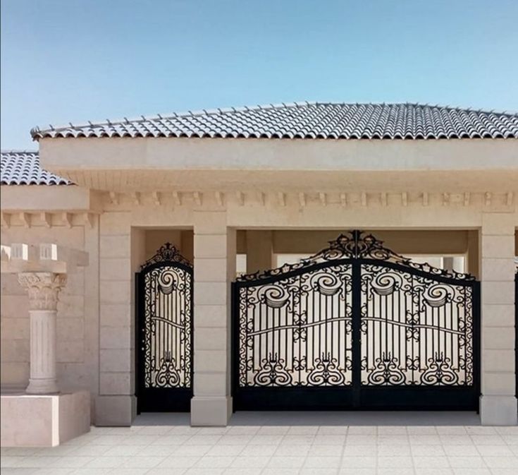 a large white building with an iron gate