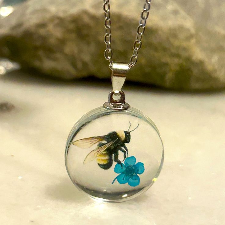 a small glass ball with a bee on it