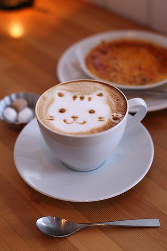 a cappuccino with a face drawn on it