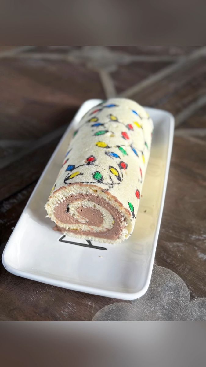 a rolled up cake on a white plate