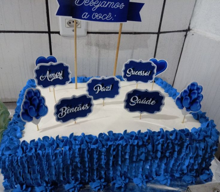 a blue and white cake with name tags on it