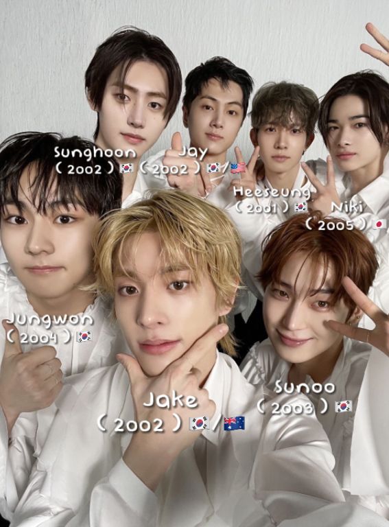 an image of the members of btob in their white outfits with hand gestures up