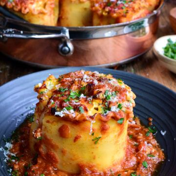 some food is sitting on a plate and ready to be eaten with another dish in the background