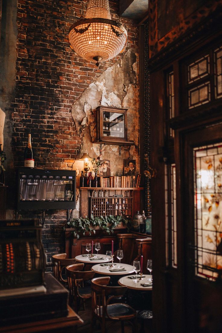 an old brick restaurant with tables and chairs