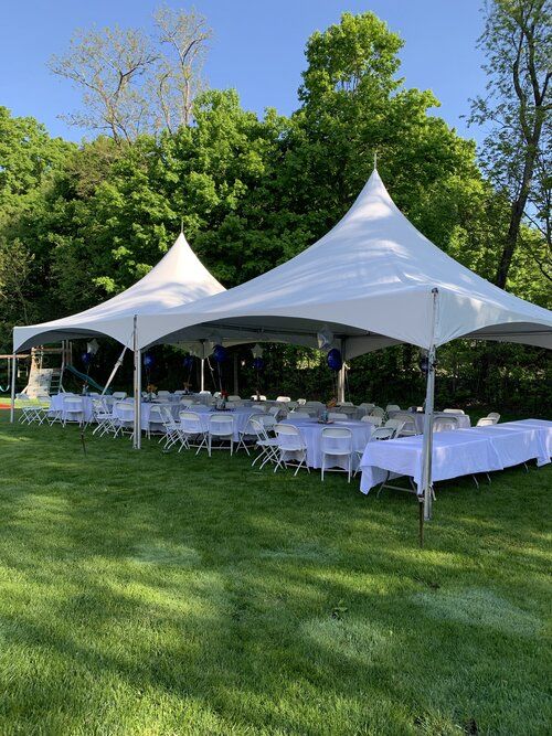 an outdoor tent set up with tables and chairs