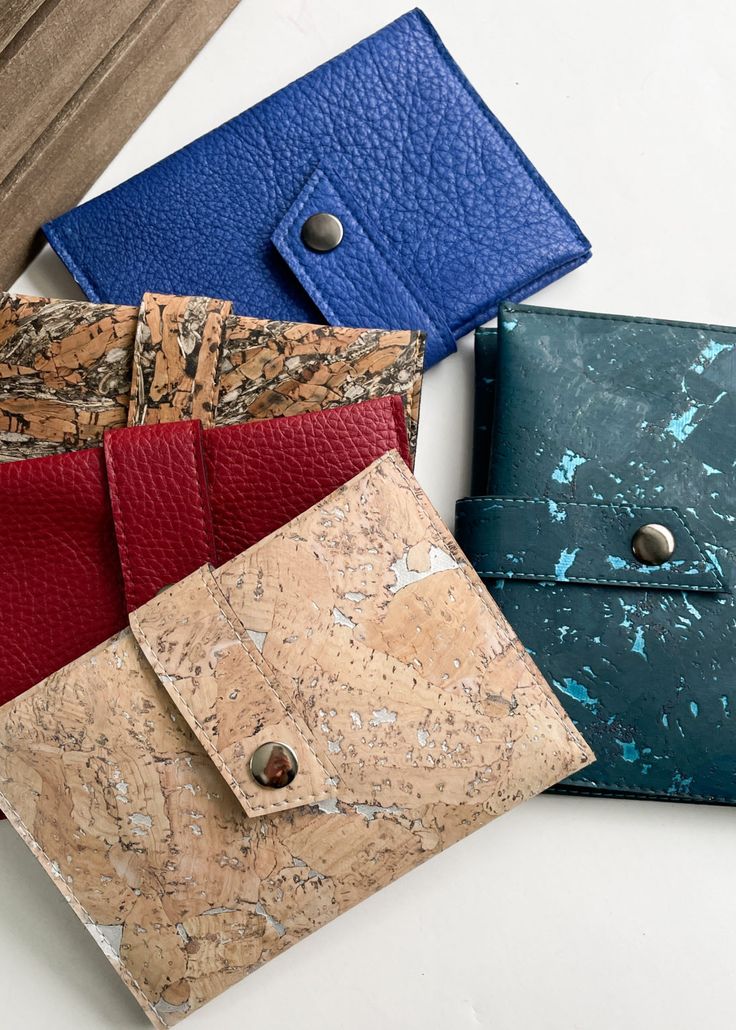 three different colored wallets sitting next to each other