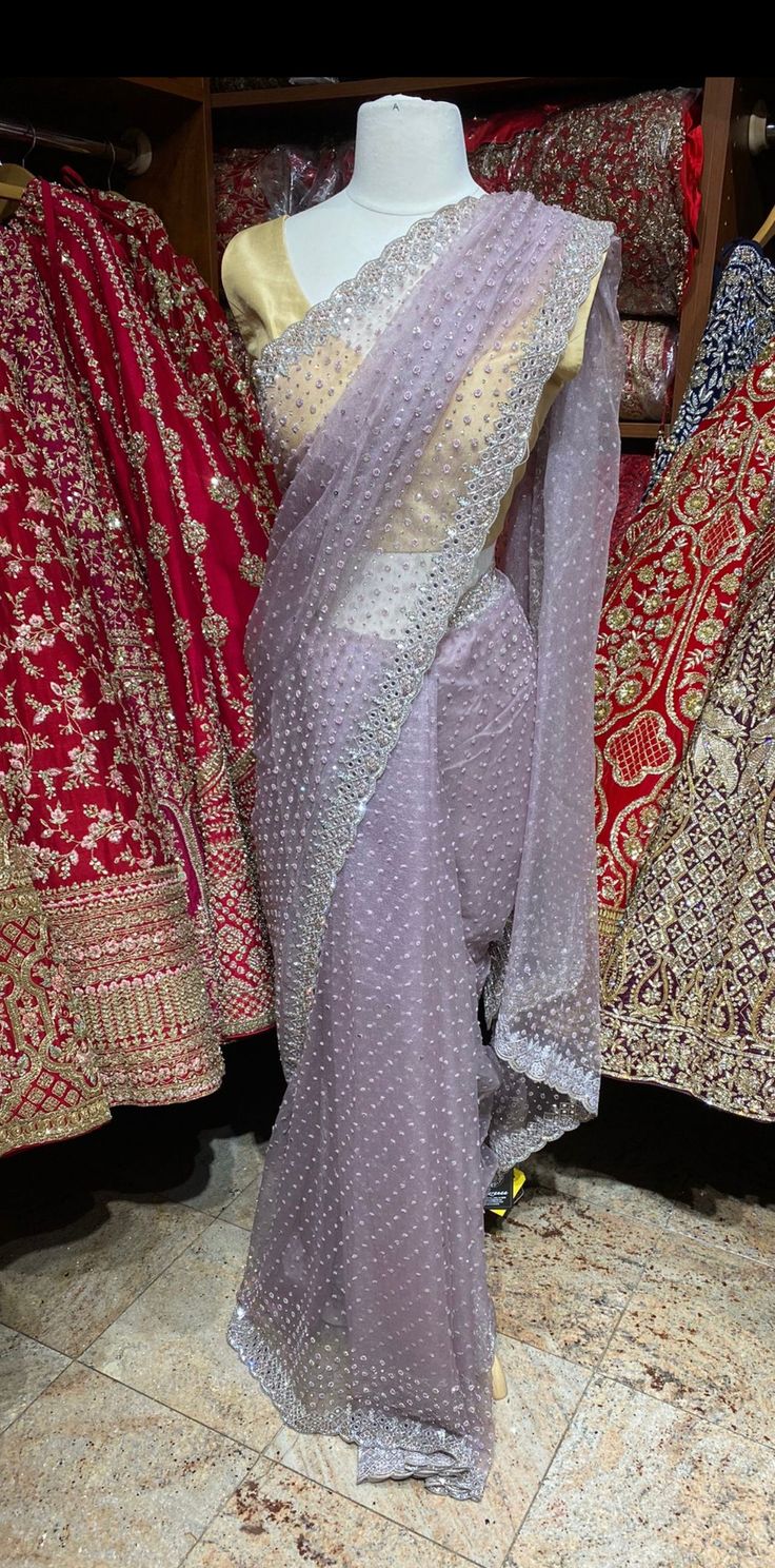 Mauve purple fabricated in net crafted with sequins, cut dana, mirror, pearl and silver zari embroidered saree. Available with unstitched blouse. Fabric: Net Ready to Ship! Traditional Organza Saree With Sequins, Purple Dupatta For Party And Navratri, Traditional Purple Pre-draped Saree For Party, Purple Pre-draped Saree For Festivals And Parties, Designer Chinon Blouse Piece In Purple, Purple Zari Work Sharara For Party, Purple Chinon Blouse Piece For Eid, Purple Tissue Silk Dupatta For Reception, Bollywood Style Purple Chinon Blouse Piece