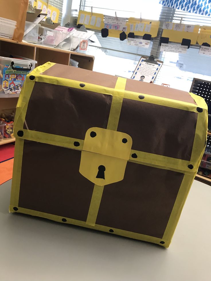 a brown and yellow trunk sitting on top of a table next to a book shelf