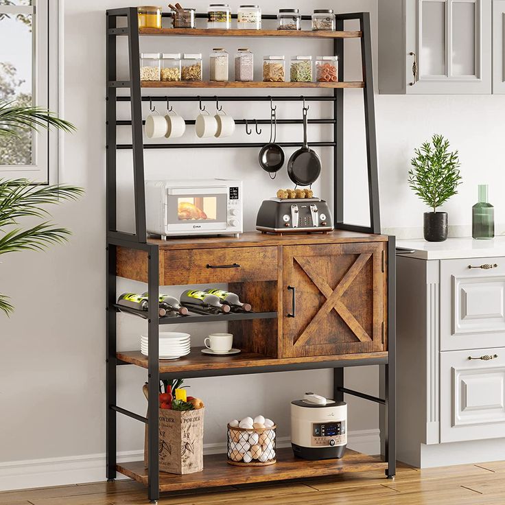 a kitchen with an open shelving unit in the center and pot racks above it