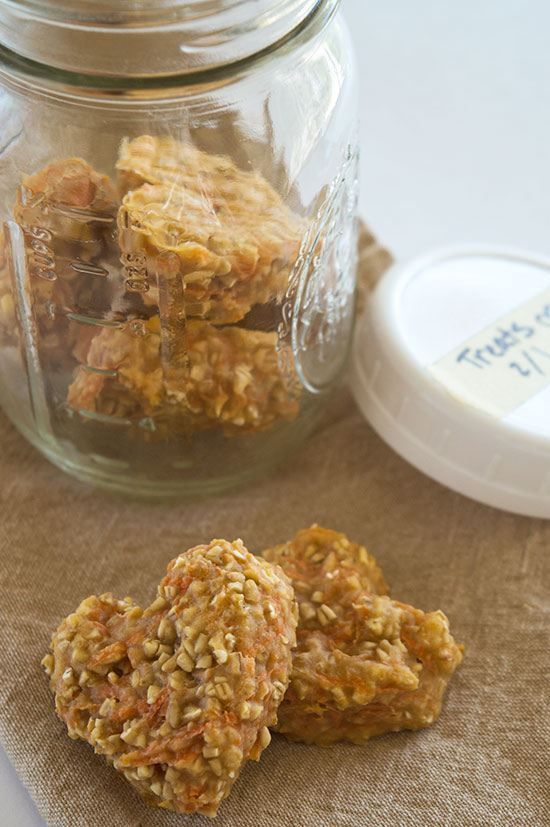 some cookies are in a glass jar on a table