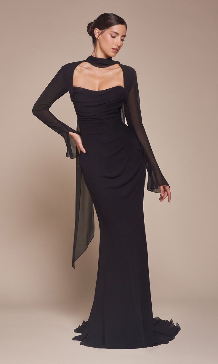 Here's a gorgeous strapless long black formal dress CD357 that is two styles in one. Whether you're looking for a stylish long sleeve black formal dress or a strapless long black evening gown, this is the perfect compromise. The glamorous long black gown has a sheer long-sleeve bolero that is completely removable to reveal a sleeker strapless style for prom, galas, and other formal events. The hip-skimming long skirt completes the look of this long black formal dress, under $150, that is embrace Gala Dresses Long Sleeve, Black Dress With Cape, Black Long Sleeve Formal Dress, Formal Dresses Long Sleeve, Long Black Formal Dress, Black Cinderella, Scoop Neck Prom Dress, Long Black Dress Formal, Chiffon Bolero