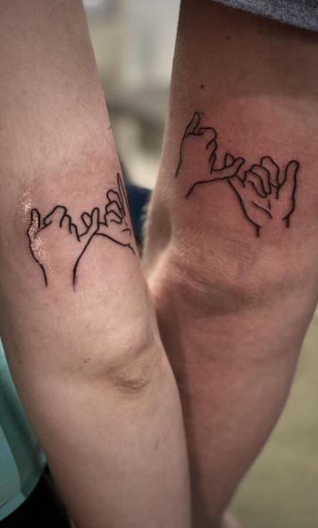 two people with matching tattoos on their arms