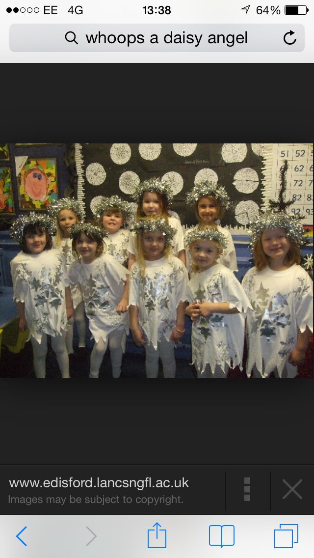 a group of children in white outfits posing for a photo