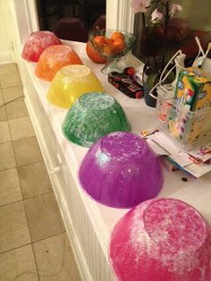 there are many different colored balls on the counter top in front of the window sill