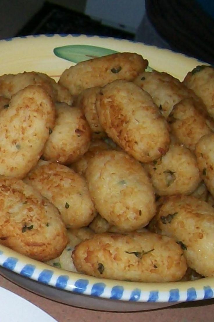 a bowl filled with fried food on top of a table