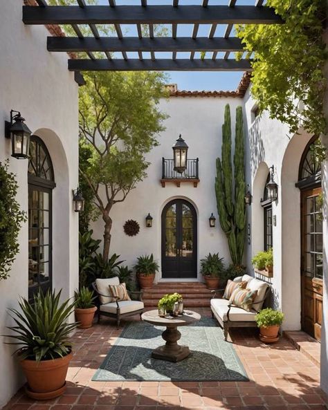 an outdoor living area with potted plants and seating on either side of the patio