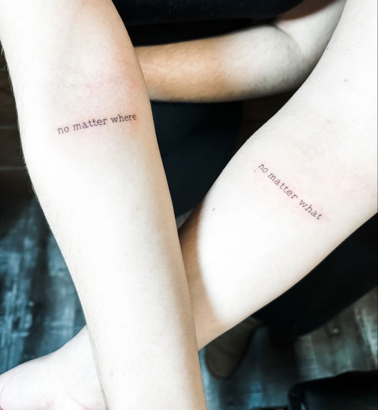 two people with tattoos on their arms that say no matter what they are doing,