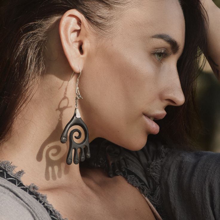 "BUDDHA'S HAND" EBONY & STERLING SILVER AMULET AND EARRINGS SET Introducing the "Buddha's Hand" Sacred Amulet and Earrings Set, a masterpiece of spiritual craftsmanship from the renowned "House of Ayaho" shaman workshop in Bali. This exquisite set is meticulously handcrafted from solid ebony and adorned with 925 sterling silver pendants, embodying the profound essence of strength and protection. 🌿✨ ▲Spiritual Significance:▼ Inspired by the serene and wise Buddha, this set symbolizes guidance, t Unique Hand Cast Drop Earrings, Handmade Symbolic Drop Earrings, Handmade Symbolic Black Earrings, Symbolic Black Hand Cast Jewelry, Unique Handmade Black Plug Earrings, Artisan Black Earrings For Festivals, Symbolic Black Earrings For Gift, Artisan Hand Cast Black Jewelry, Artisan Black Hand Cast Jewelry