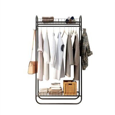 an iron rack with clothes hanging on it