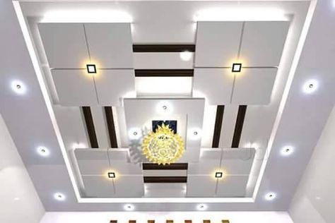 the ceiling in this room is decorated with white and gold accents, along with recessed lighting