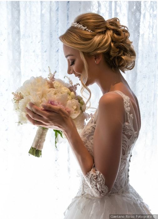 a woman in a wedding dress holding a bouquet