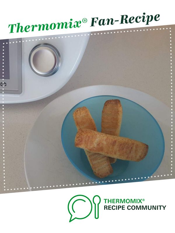 there is a plate with some bread sticks on it and thermometer next to it