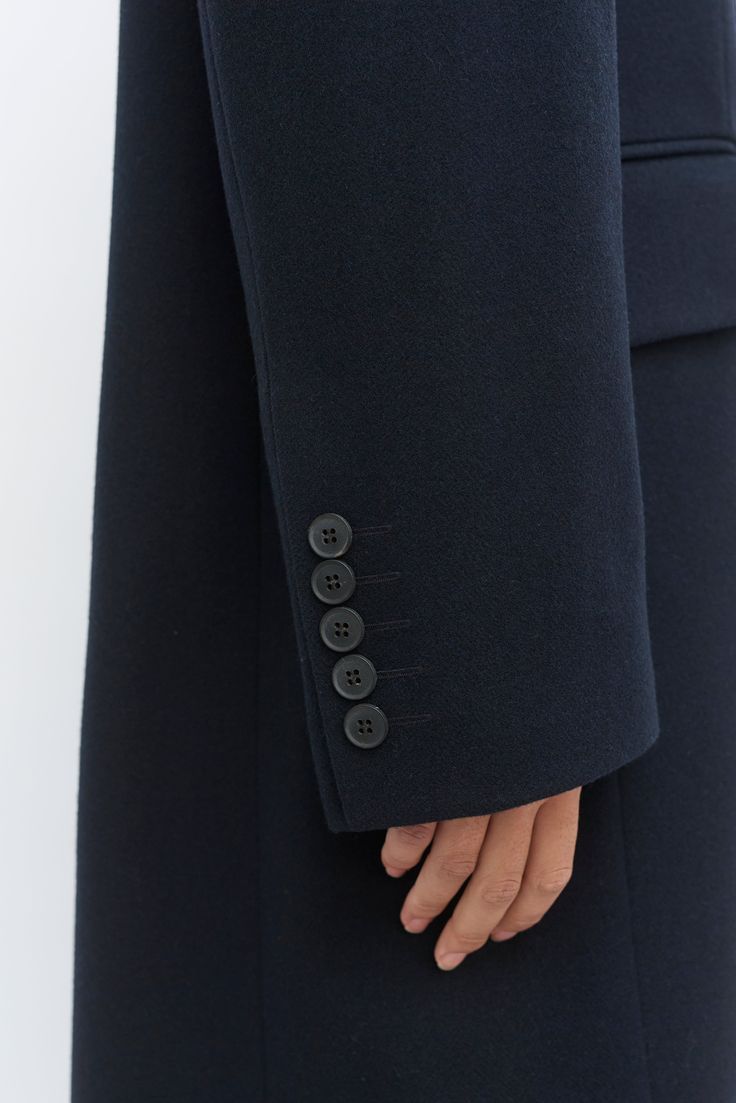 Our oversized double breasted tailored navy wool coat is made with 100% wool woven in Yorkshire. The lining is sustainable made from FSC & Eco Vera viscose. The coat is long in length, it features an oversized lapel detail, horn buttons and two front pockets with a flap. The thread used on this garments is sustainable. Navy Wool Coat, Navy Coat, Wool Coat, Yorkshire, Horn, Double Breasted, Thread, Wool, Navy