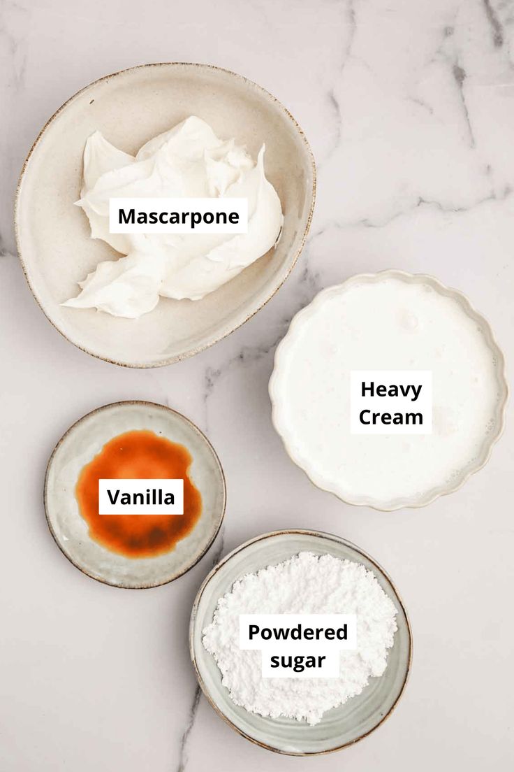 three bowls filled with different types of food on top of a white marble countertop