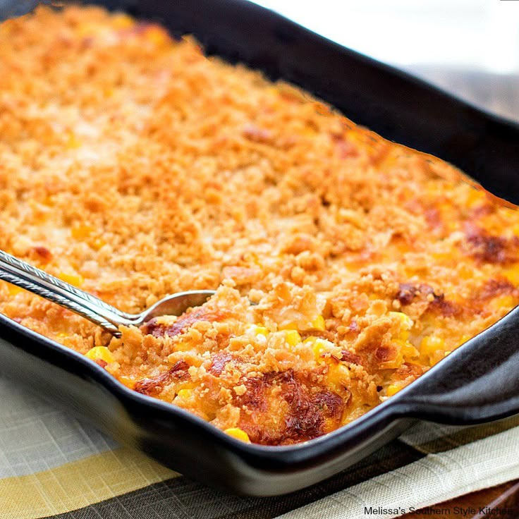 a close up of a casserole in a pan with a fork on the side