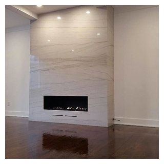 an empty room with a fireplace and white walls